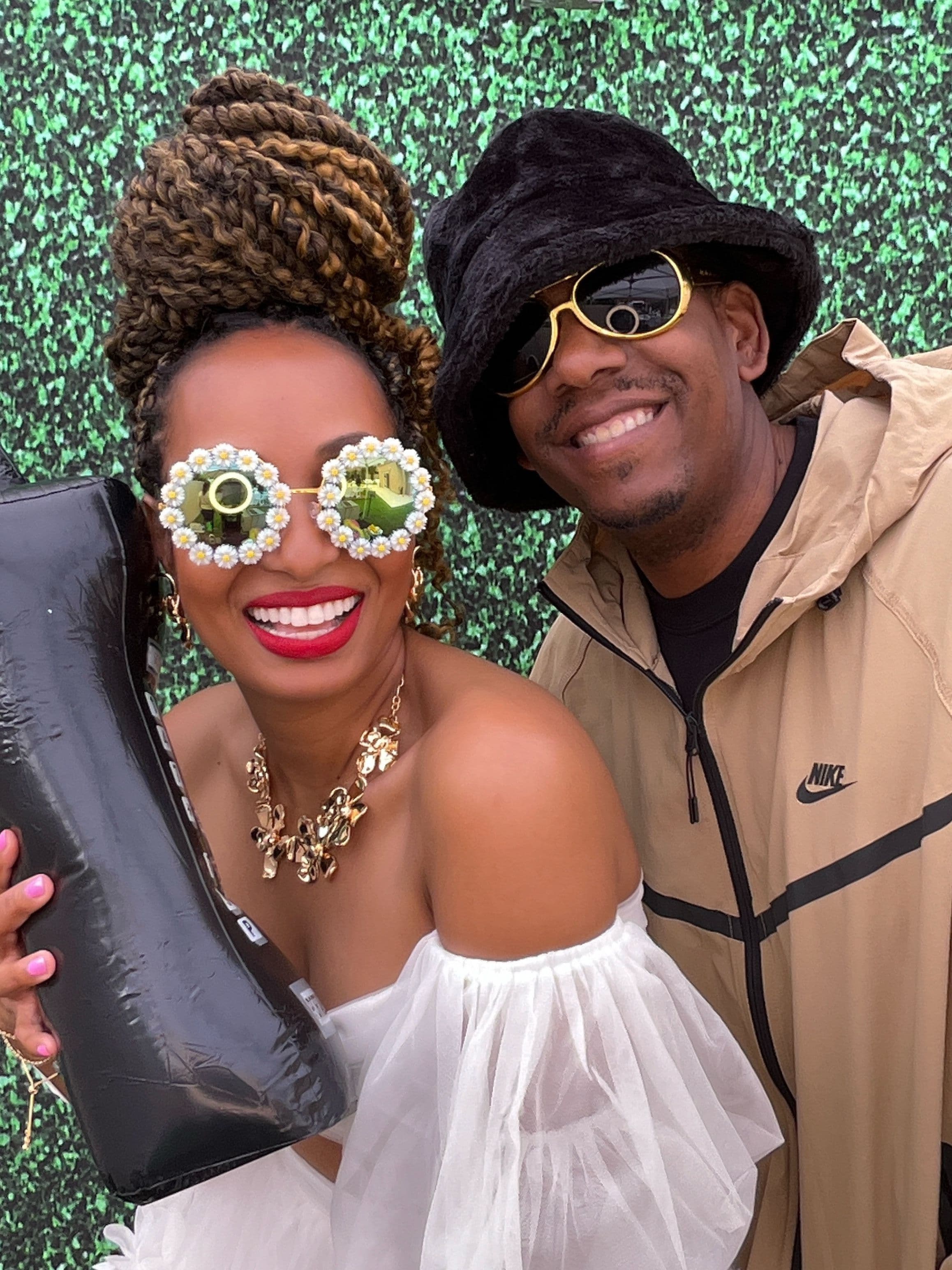 A couple enjoying the photo booth at Birthday event.