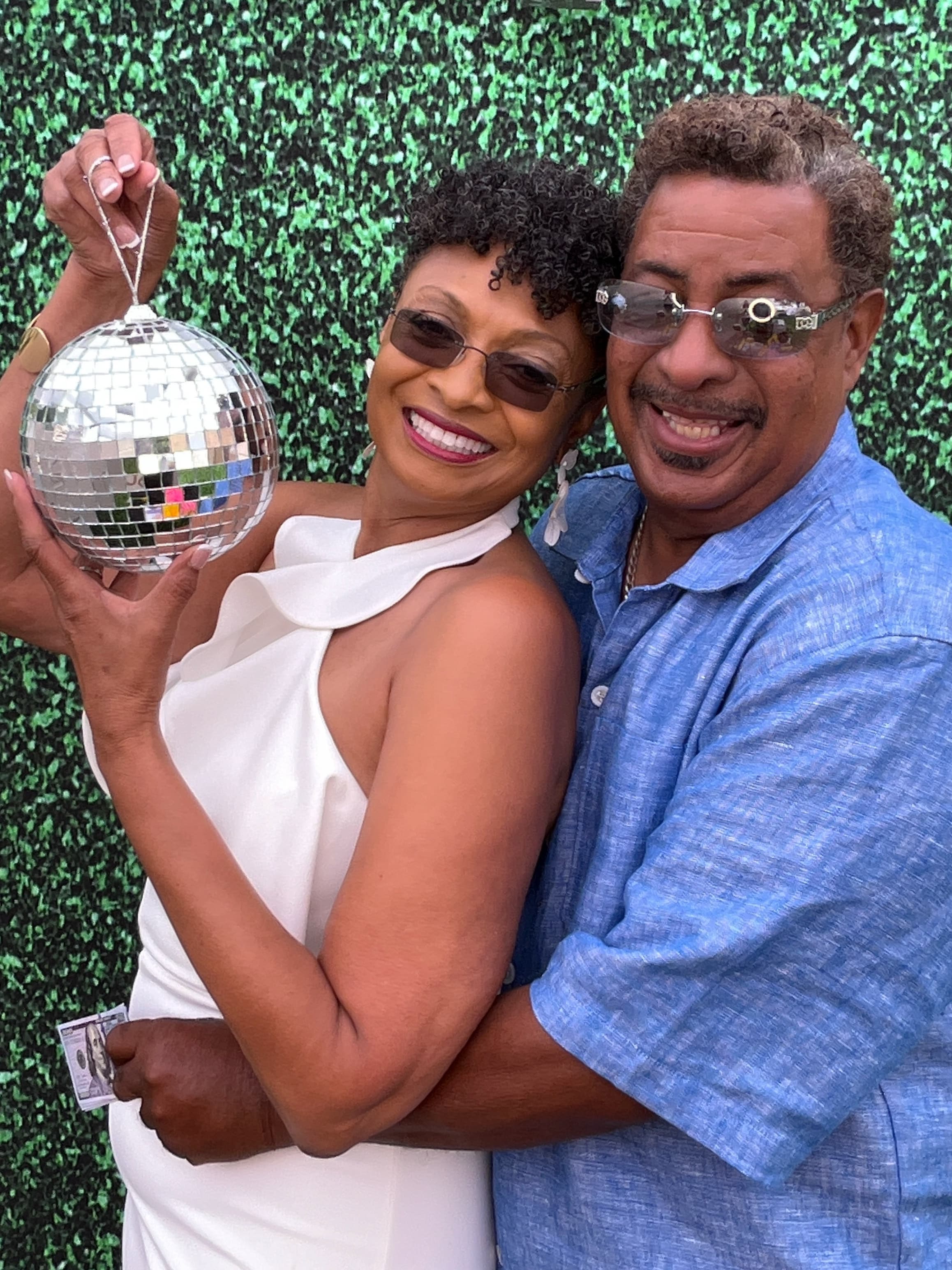 Guests posing with a prop and crown celebrating at an event