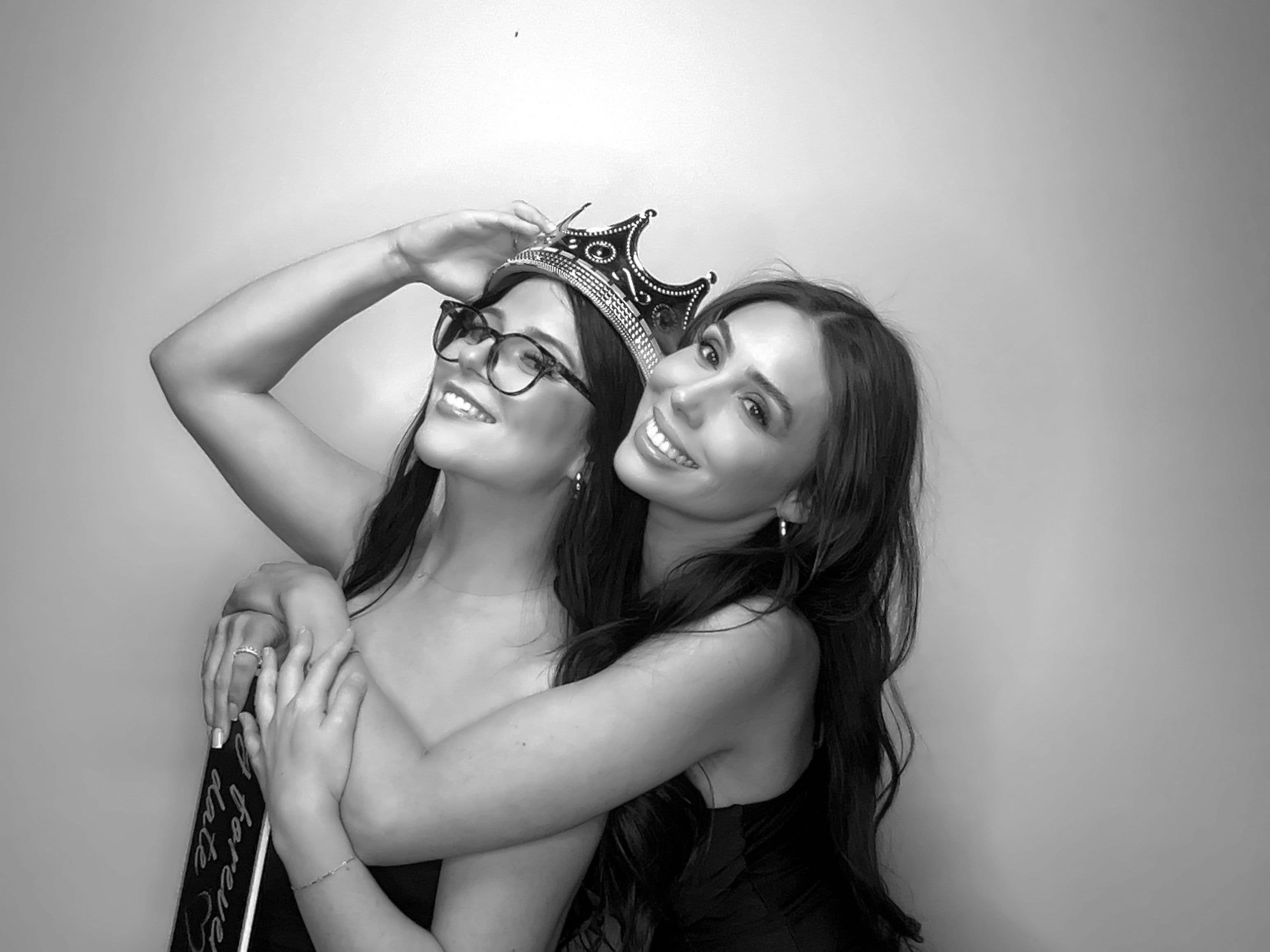 Two guests posing for a black-and-white Glam Photo Booth wedding held in the city of Fontana.